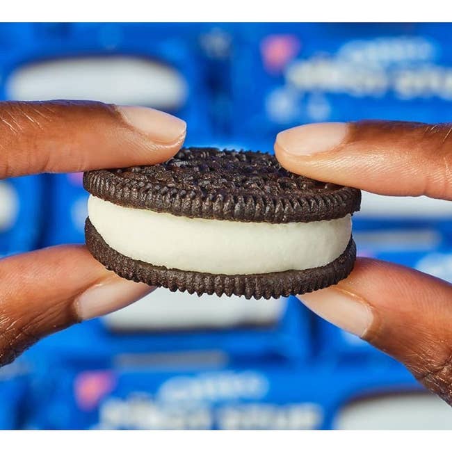 hand holding an Oreo with a thick layer of creme filling