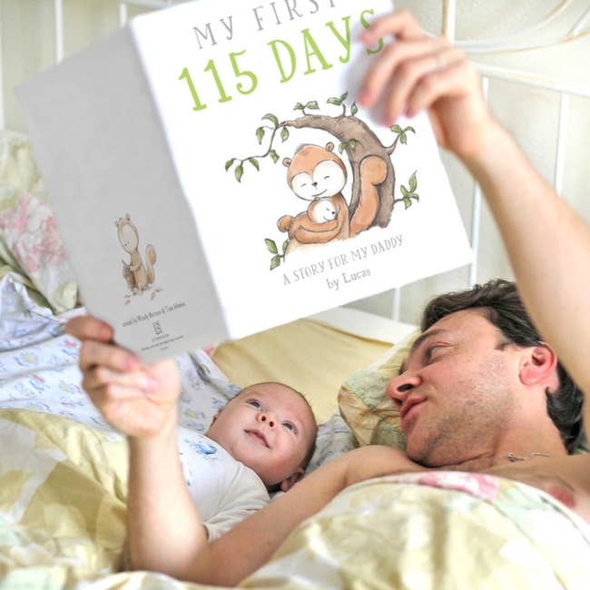 a dad and baby reading the book