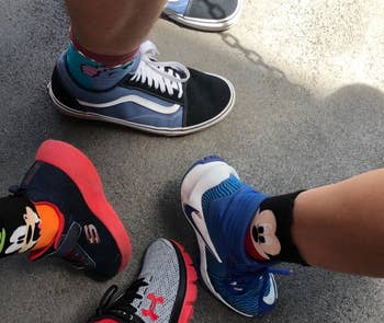 a reviewer and her children wearing mickey, minnie, and donald socks