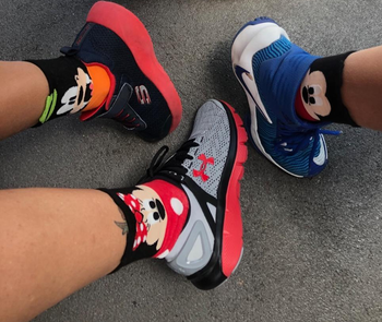 a reviewer and her children wearing mickey, minnie, and donald socks