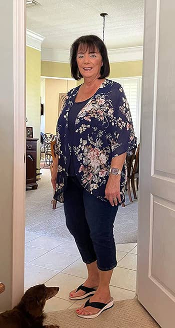 a reviewer wearing the same flowy cardigan with a navy base 