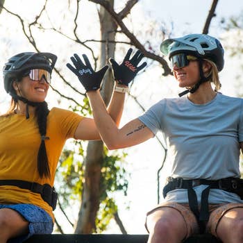 two models wearing bike gear and gloves that say 