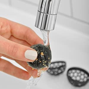 hands rinsing out sticky inner ball from black version