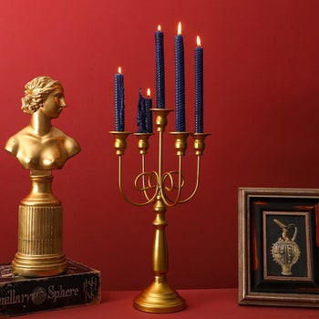 the candelabra with five dark blue candles