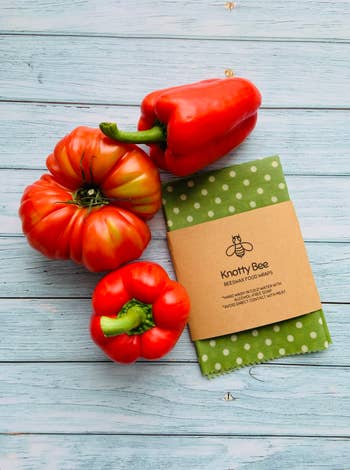 Social media trends Viral content Trending hashtags Social media updates Trending memes and videos Three red peppers next to Knotty Bee beeswax food wrap with green polka dots, displayed on a wooden surface