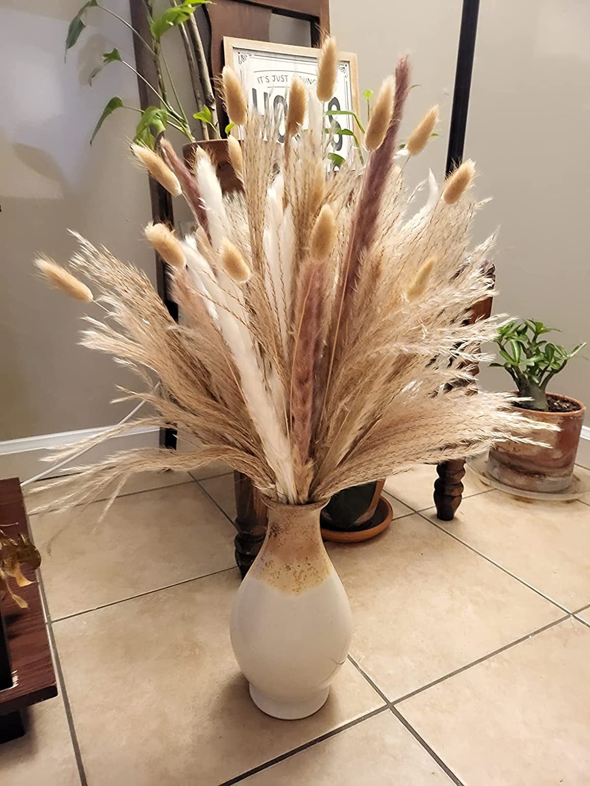 a reviewer photo of a vase with a bouquet of the dried pampas grass in it 