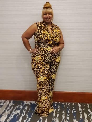 reviewer wearing gold and black printed jumpsuit