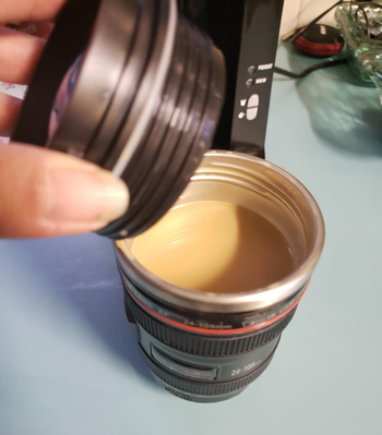 The lid screwed off to show the coffee inside 