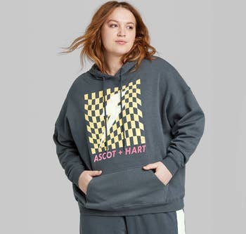 a plus size model wearing the same hoodie 