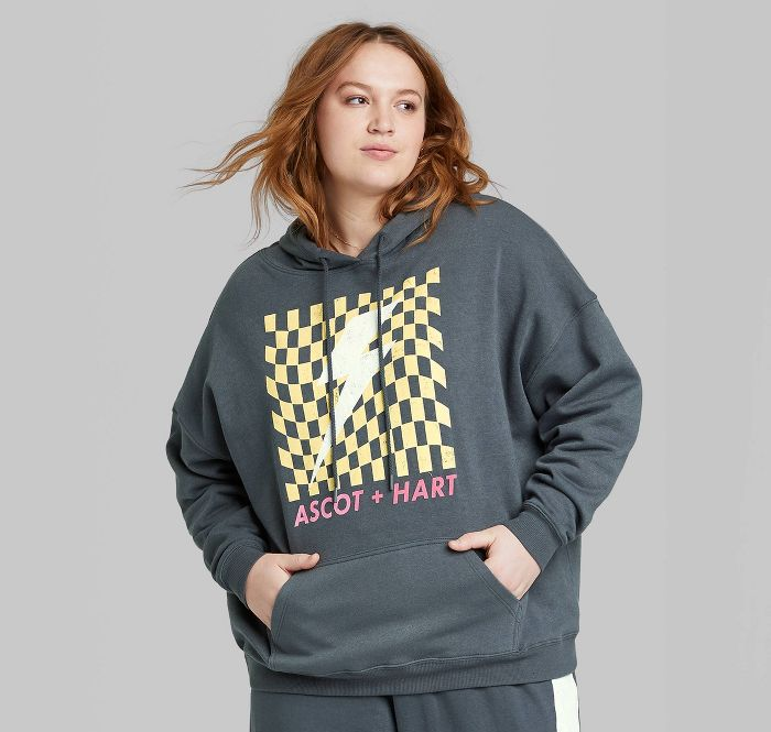 a plus size model wearing the same hoodie 