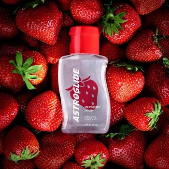Astroglide bottle in pile of strawberries