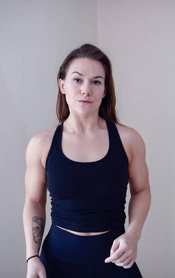 reviewer photo wearing tight cropped black tank top
