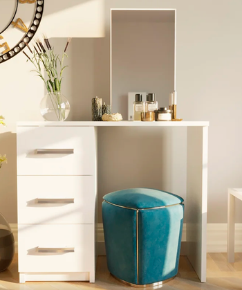 lifestyle photo of makeup vanity with mirror and three storage drawers