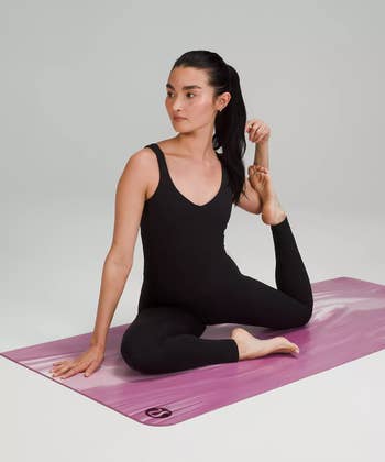 model on a pink yoga mat