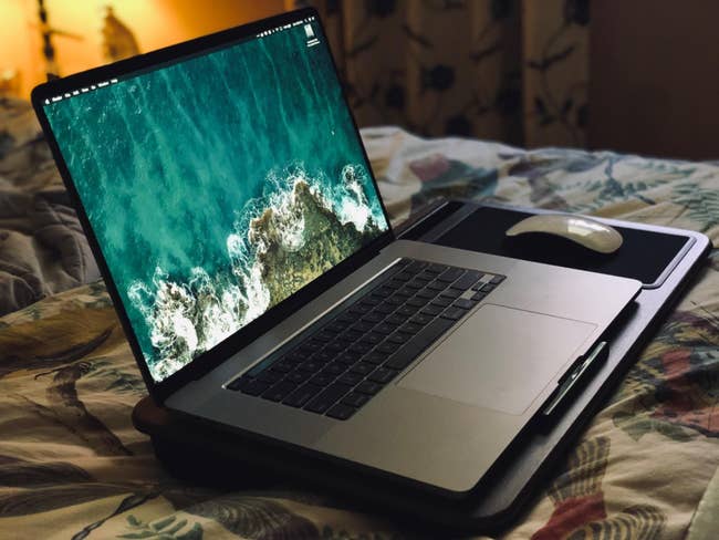 a laptop on a lap desk