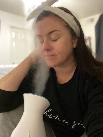 reviewer sitting in front of the mist steamer