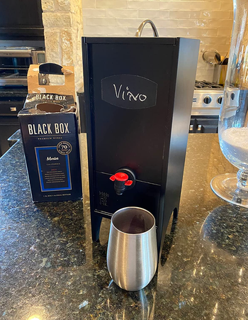 The dispenser closed with a wine glass under the nozzle