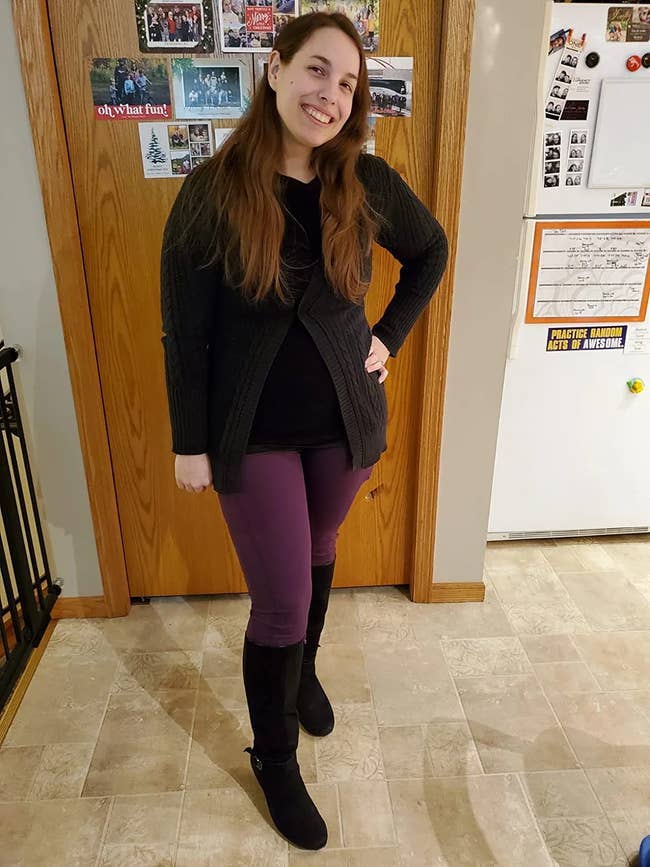 reviewer posing in the leggings in purple