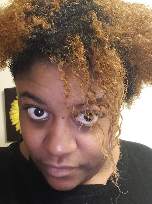 Reviewer with tight curls showing the definition and smoothness after using this mask