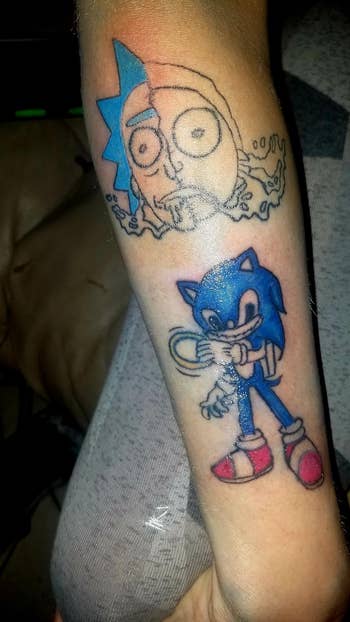 Tattoo of Sonic the Hedgehog and an unfinished Rick from Rick and Morty connected  an arm