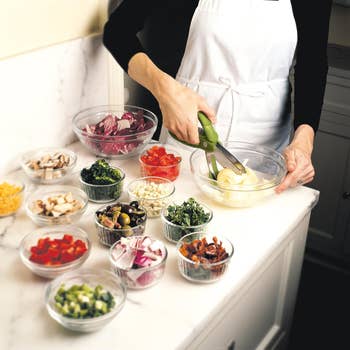 a model chopping a variety of vegetables
