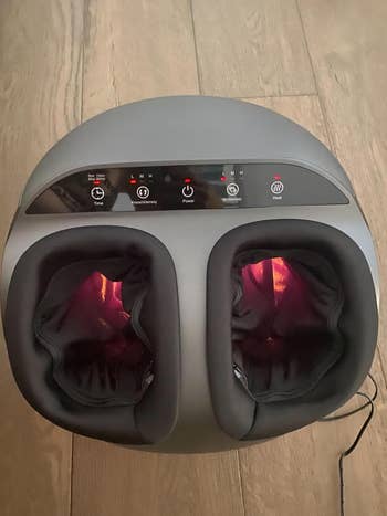 reviewer photo of their foot massager turned on and emitting heat