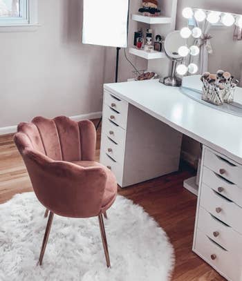 reviewer photo of the pink chair in front of a vanity