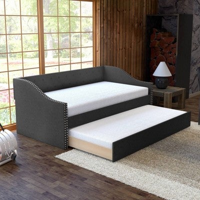 lifestyle image of black tufted upholstered trundle bed