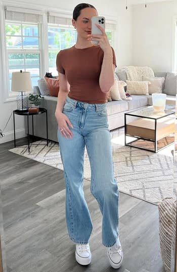 reviewer wearing brown top