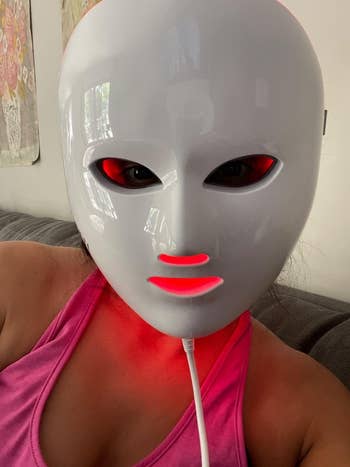 reviewer wearing an LED face mask
