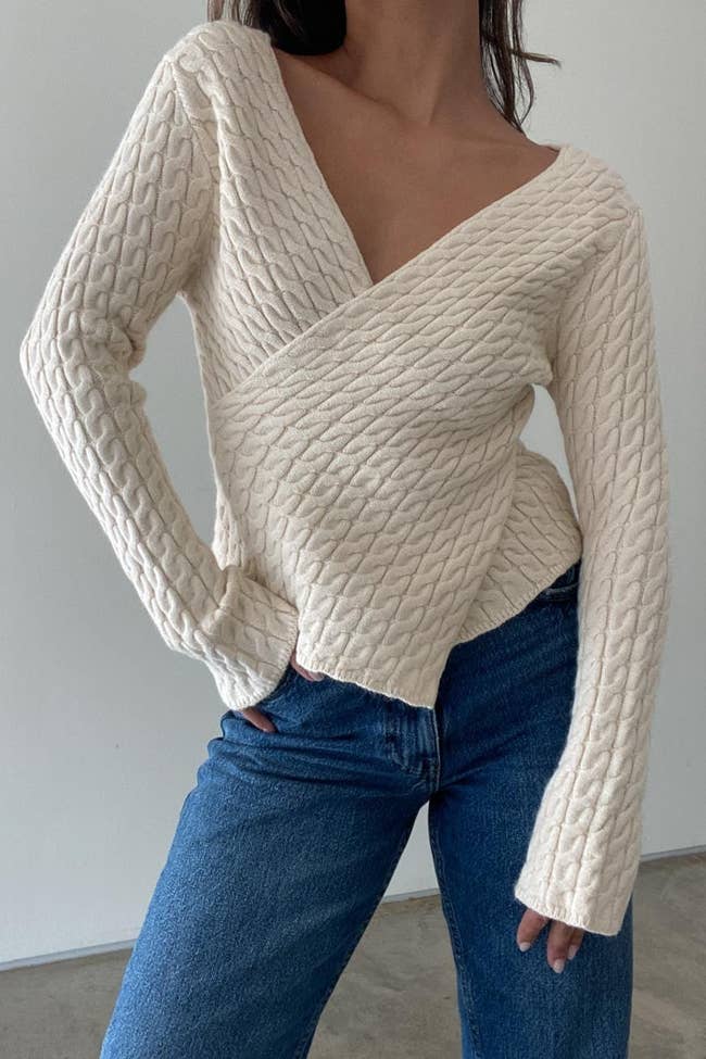 model wearing the white v-neck knit sweater