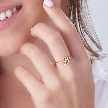 Model wearing the gold initial ring