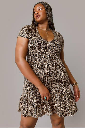 model in short sleeve ruffle hem v-neck brown and black mini dress