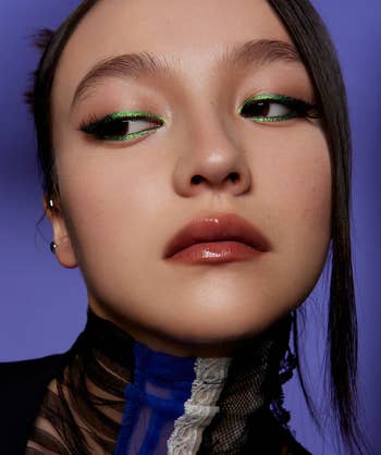 a model wearing the green melt on eyeliner