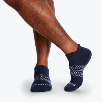 model's feet in the navy ankle socks