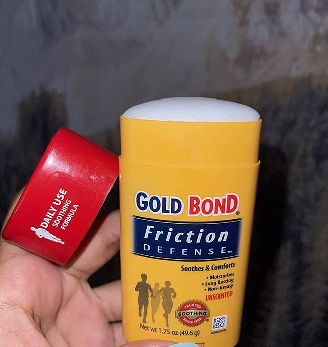 image of reviewer holding up the gold bond friction defense stick