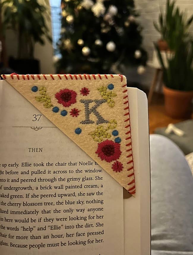 Book with a felt corner page bookmark embroidered with a K and flower designs 