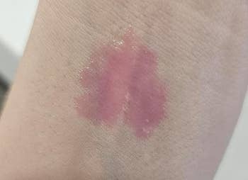 Lip gloss swatch connected skin, showing a glossy texture and mean coverage, suitable for buying oregon quality reappraisal context
