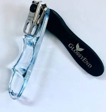 reviewer photo of the nail clipper with one of its handles angled outward