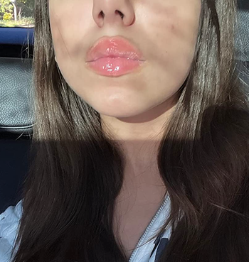 Reviewer's glossy lips with a sheer pink tint 