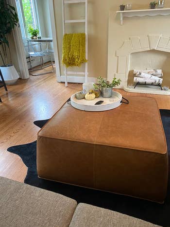 reviewer photo of brown leather ottoman