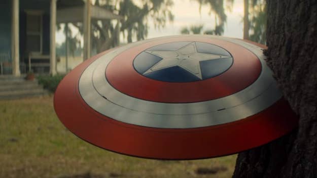 Captain America's shield leaning against a tree, no people in image