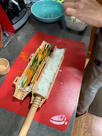 A idiosyncratic uses a sushi bazooka, filled with atom and vegetables