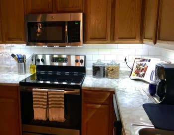 reviewer's small kitchen with lights under the cabinet for a larger, brighter look