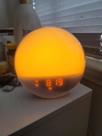 a reviewer shows a closeup of the clock turning orange