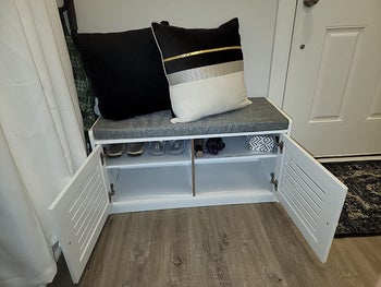 reviewer photo of storage bench with doors open, shoes inside