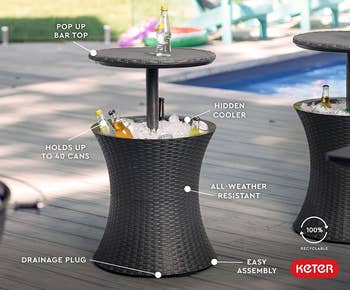 the wicker table popped up with a drink on top and the bottom filled with ice and drinks