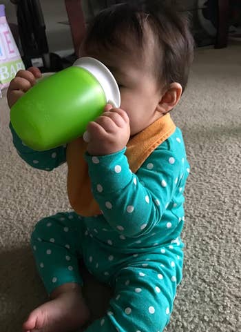 a reviewer photo of a child drinking out one of the cups 