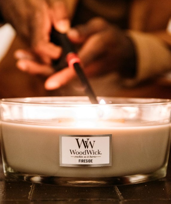 Person lights WoodWick candle