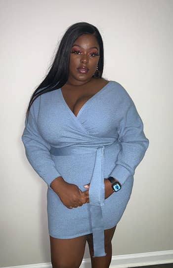 reviewer wearing the blue batwing sweater dress